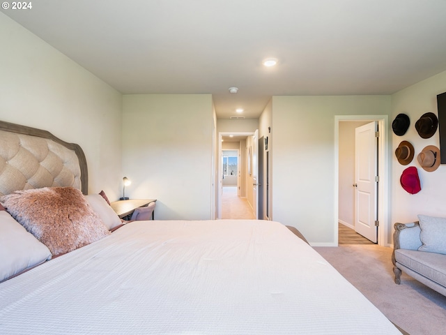 bedroom with recessed lighting, light colored carpet, and baseboards