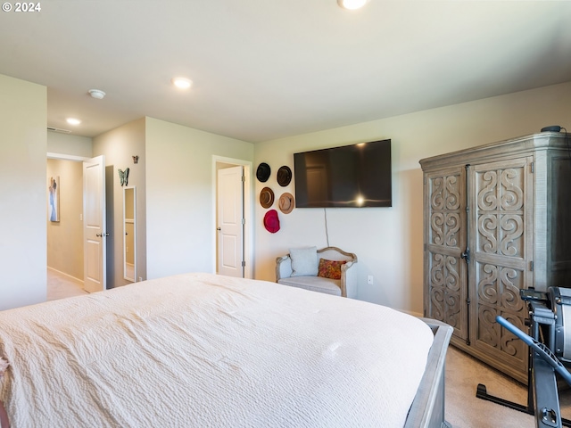 bedroom with light carpet and recessed lighting