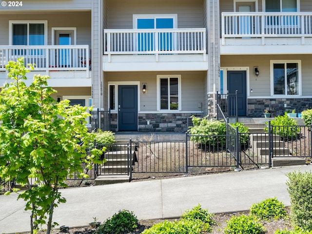 exterior space with stone siding and fence