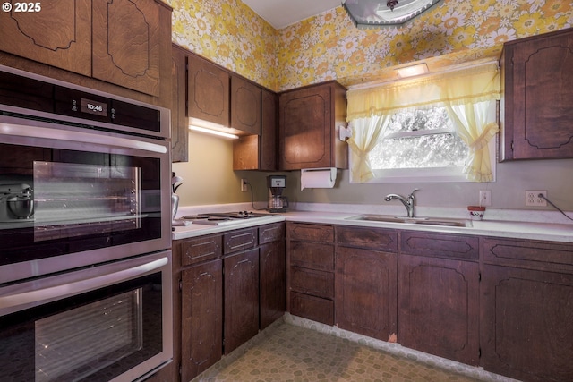 48025 NW Strohmayer Rd, Forest Grove, OR 97116 - kitchen with a sink, wallpapered walls, cooktop, double oven, and light countertops