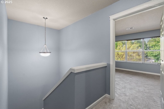 2820 23rd Pl, Forest Grove, OR 97116 - corridor featuring carpet floors, baseboards, a textured ceiling, and an upstairs landing