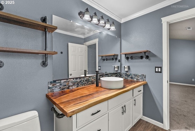 2820 23rd Pl, Forest Grove, OR 97116 - half bathroom with crown molding, vanity, toilet, baseboards, and decorative backsplash