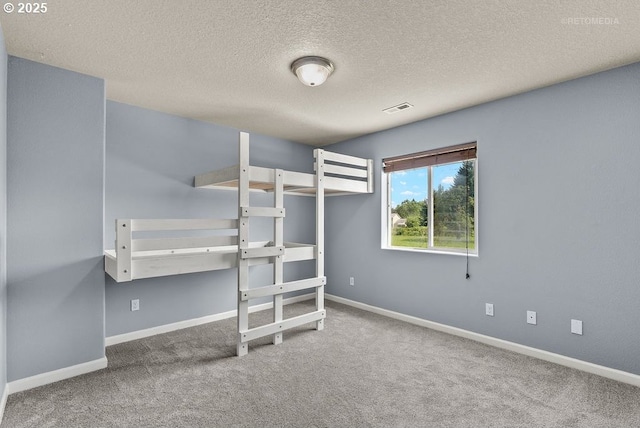 2820 23rd Pl, Forest Grove, OR 97116 - unfurnished bedroom with carpet flooring, baseboards, and a textured ceiling