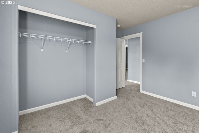 2820 23rd Pl, Forest Grove, OR 97116 - unfurnished bedroom featuring a closet, carpet flooring, baseboards, and a textured ceiling