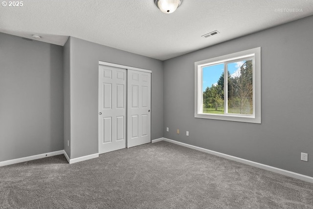 2820 23rd Pl, Forest Grove, OR 97116 - unfurnished bedroom featuring a closet, a textured ceiling, carpet, and baseboards