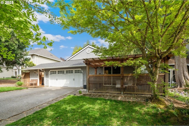ranch-style home featuring asphalt driveway, a garage, and a pergola
