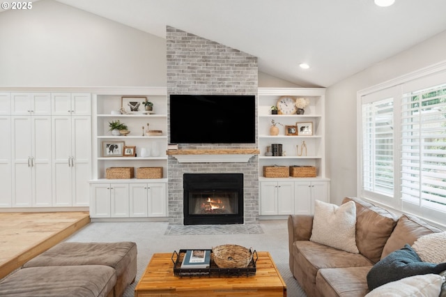 carpeted living room featuring lofted ceiling, a brick fireplace, built in shelves, and recessed lighting