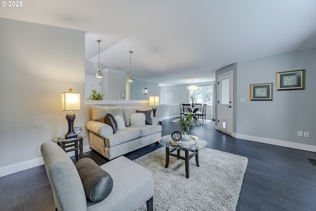 living area featuring dark wood finished floors and baseboards