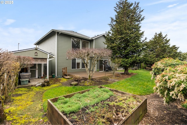 back of house with a garden, a lawn, and a patio area