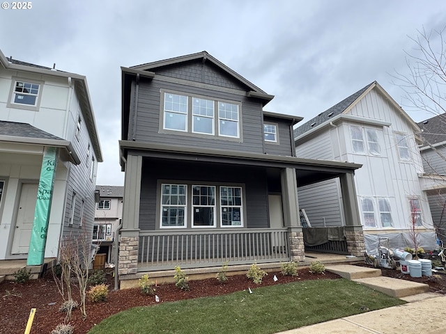 craftsman house featuring stone siding and a porch