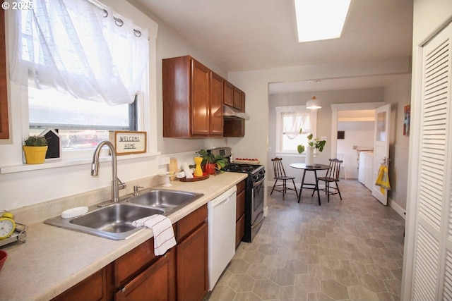 kitchen featuring pendant lighting, washer / clothes dryer, dishwasher, sink, and stainless steel range with gas stovetop