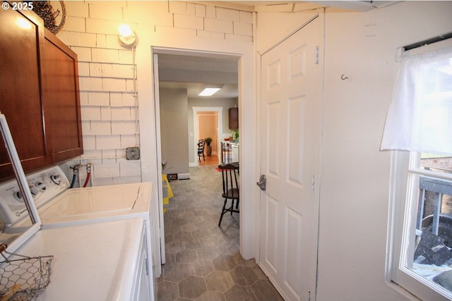 laundry area with cabinets and washer and clothes dryer