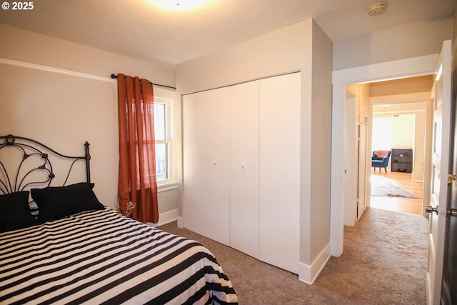 carpeted bedroom with a closet