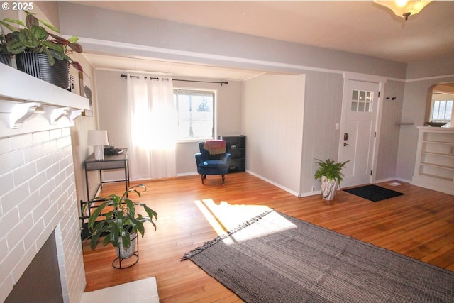 foyer with a fireplace and light wood-type flooring