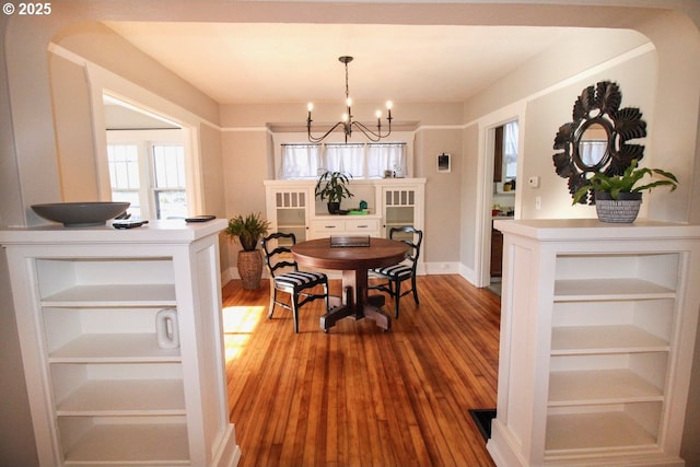 dining space with an inviting chandelier and hardwood / wood-style floors