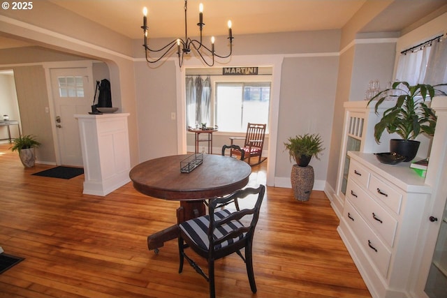 dining room featuring light hardwood / wood-style flooring and a notable chandelier