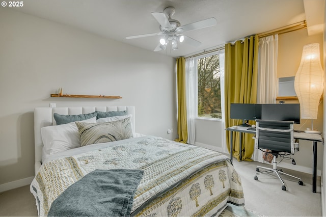 carpeted bedroom with a ceiling fan and baseboards