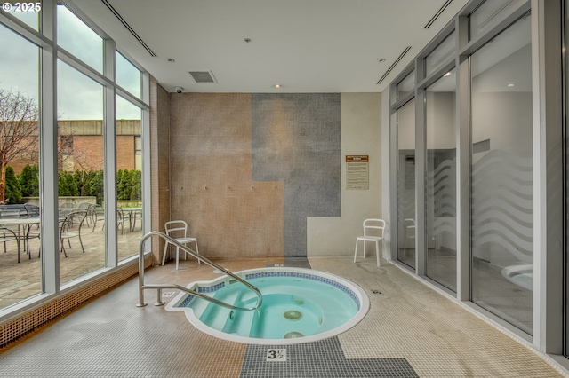 view of swimming pool with an indoor in ground hot tub