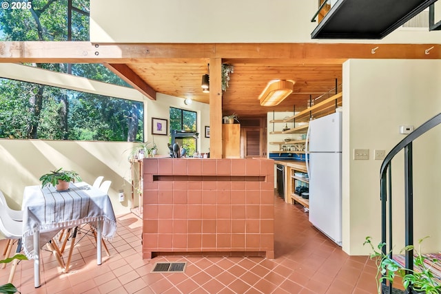 2696 Moon Mountain Dr, Eugene, OR 97403 - kitchen with freestanding refrigerator, tile patterned flooring, wood ceiling, tile counters, and open shelves