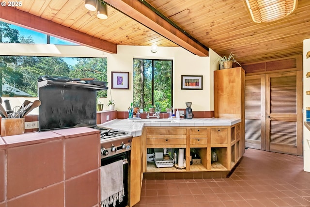 2696 Moon Mountain Dr, Eugene, OR 97403 - kitchen featuring tile patterned flooring, tile counters, and a wood ceiling with exposed beams