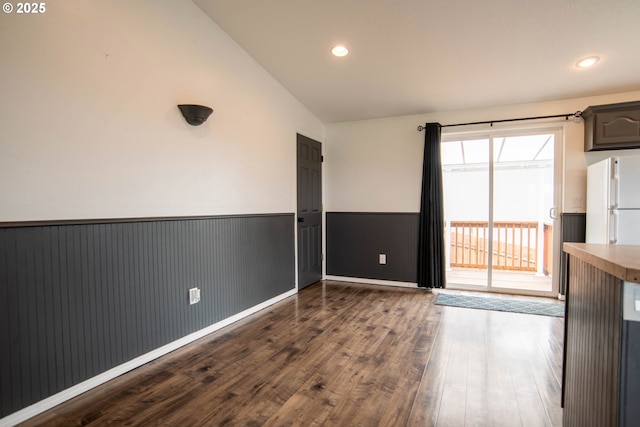 906 N Railroad Ave, Ridgefield, WA 98642 - unfurnished dining area with a wainscoted wall, vaulted ceiling, dark wood-style flooring, and recessed lighting