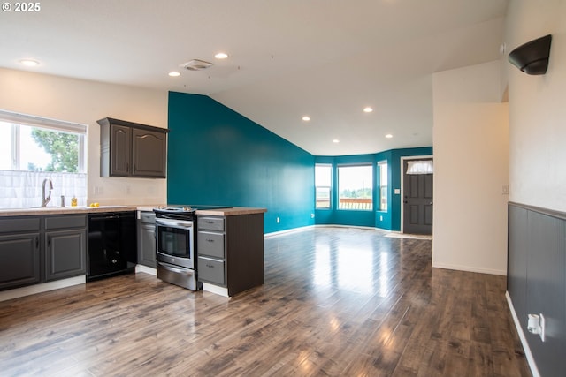 906 N Railroad Ave, Ridgefield, WA 98642 - kitchen featuring black dishwasher, stainless steel electric range oven, open floor plan, lofted ceiling, and a peninsula
