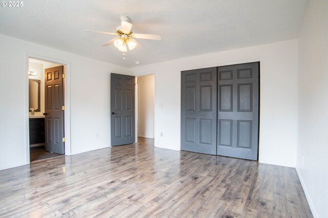 906 N Railroad Ave, Ridgefield, WA 98642 - unfurnished bedroom with a closet, wood finished floors, ensuite bathroom, and a ceiling fan