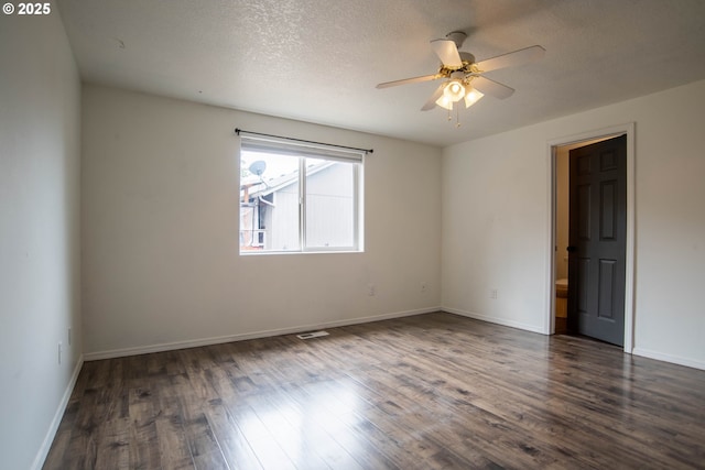 906 N Railroad Ave, Ridgefield, WA 98642 - spare room with a ceiling fan, dark wood-type flooring, and a textured ceiling