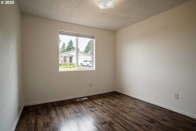 906 N Railroad Ave, Ridgefield, WA 98642 - spare room with dark wood-type flooring