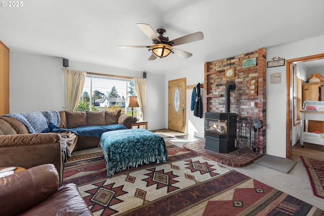 878 NW Warrenton Dr, Warrenton, OR 97146 - carpeted living area with a wood stove and ceiling fan