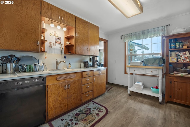 878 NW Warrenton Dr, Warrenton, OR 97146 - kitchen featuring open shelves, light wood-type flooring, light countertops, black dishwasher, and a sink