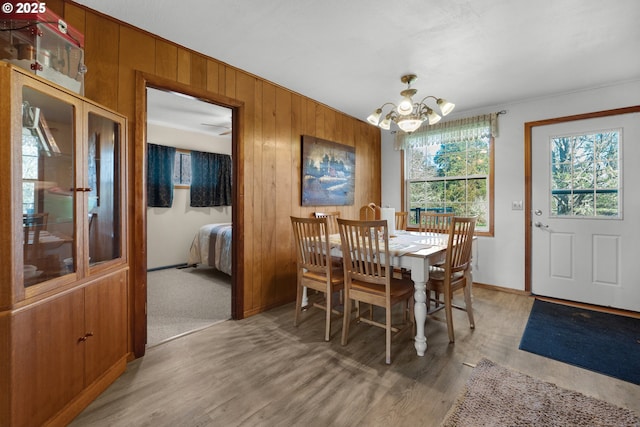 878 NW Warrenton Dr, Warrenton, OR 97146 - dining room with light wood finished floors, wood walls, and an inviting chandelier