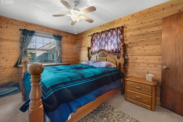 878 NW Warrenton Dr, Warrenton, OR 97146 - carpeted bedroom featuring ceiling fan and wood walls