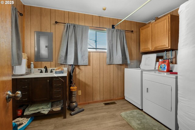 878 NW Warrenton Dr, Warrenton, OR 97146 - laundry area featuring visible vents, wood walls, electric panel, separate washer and dryer, and a sink