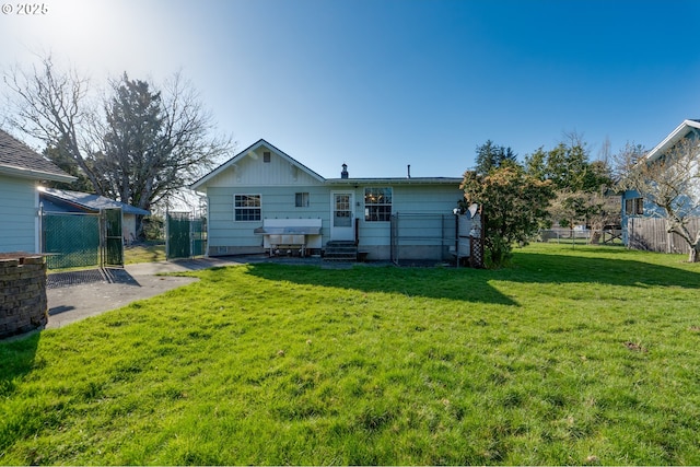 878 NW Warrenton Dr, Warrenton, OR 97146 - back of property featuring entry steps, fence, and a lawn