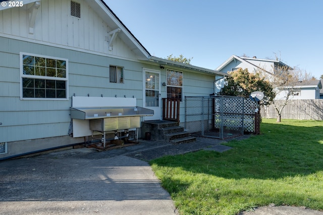 878 NW Warrenton Dr, Warrenton, OR 97146 - view of front of home with a front yard and fence