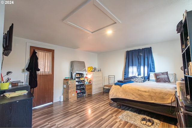 bedroom with wood-type flooring and multiple windows