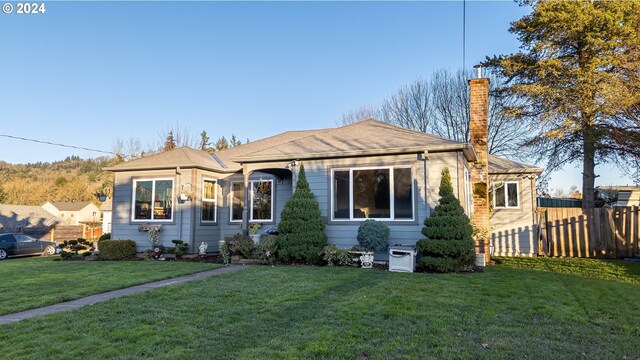 111 N Trade St, Amity, OR 97101 - bungalow with a front yard, fence, and a chimney