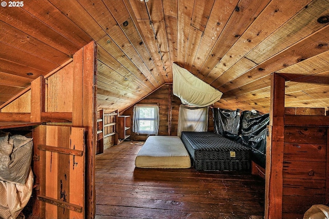 unfurnished bedroom featuring lofted ceiling, wood ceiling, and hardwood / wood-style floors