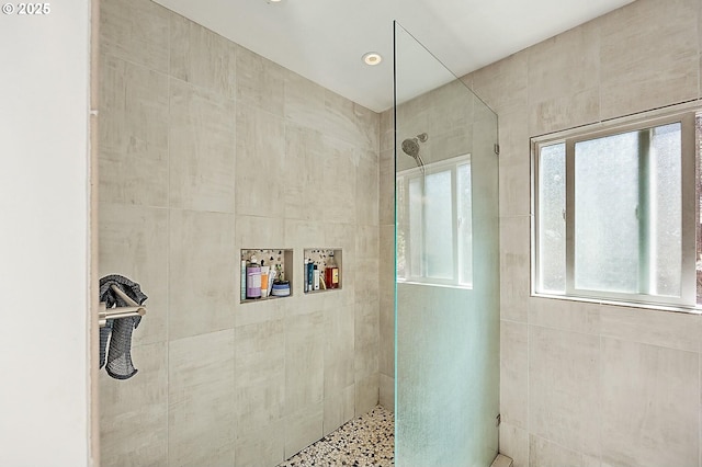 bathroom with tiled shower