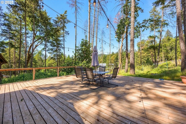 wooden terrace featuring outdoor dining space