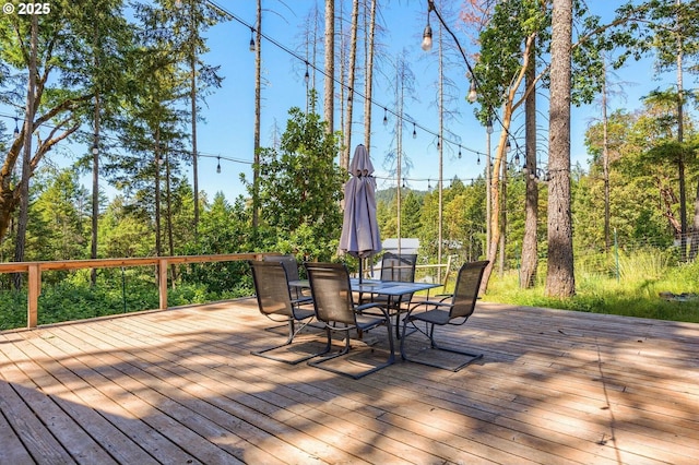 wooden terrace featuring outdoor dining space