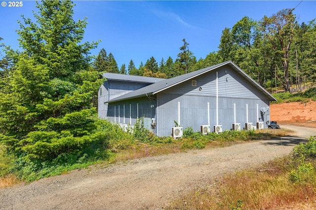 view of side of home with ac unit