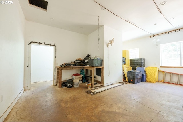 misc room featuring a workshop area and concrete floors