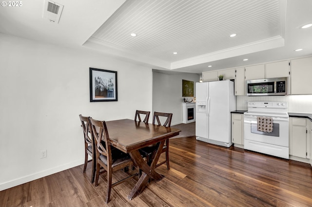117 E Cushman St, Yacolt, WA 98675 - dining room with a tray ceiling, recessed lighting, dark wood-style flooring, and baseboards