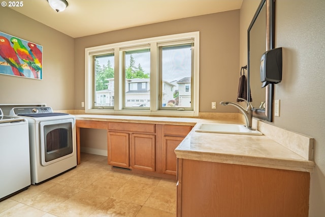washroom featuring washer and clothes dryer and cabinet space