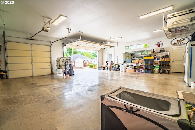 garage featuring fridge and a garage door opener