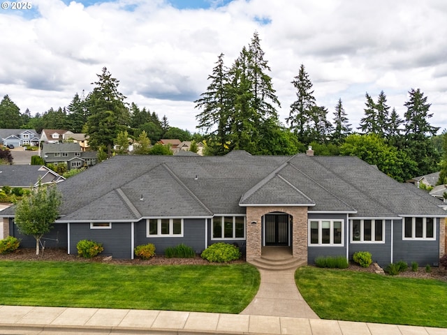 ranch-style home with a front lawn, roof with shingles, and a chimney