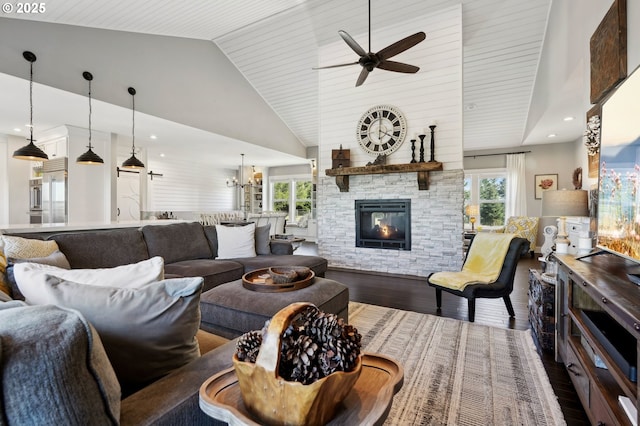 20265 SE Poco Ln, Amity, OR 97101 - living area featuring dark wood-style floors, ceiling fan, healthy amount of natural light, a fireplace, and high vaulted ceiling