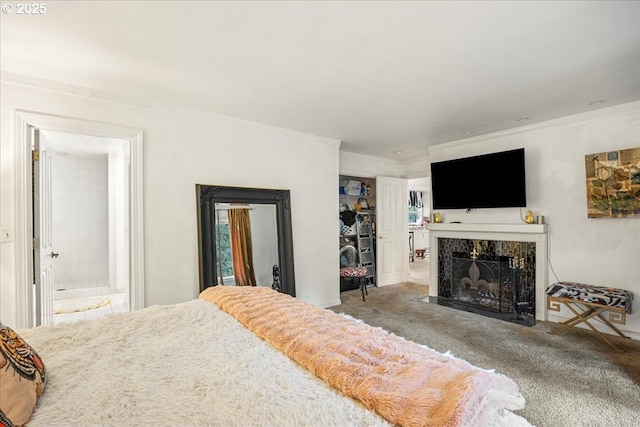 bedroom featuring a high end fireplace, ornamental molding, and carpet